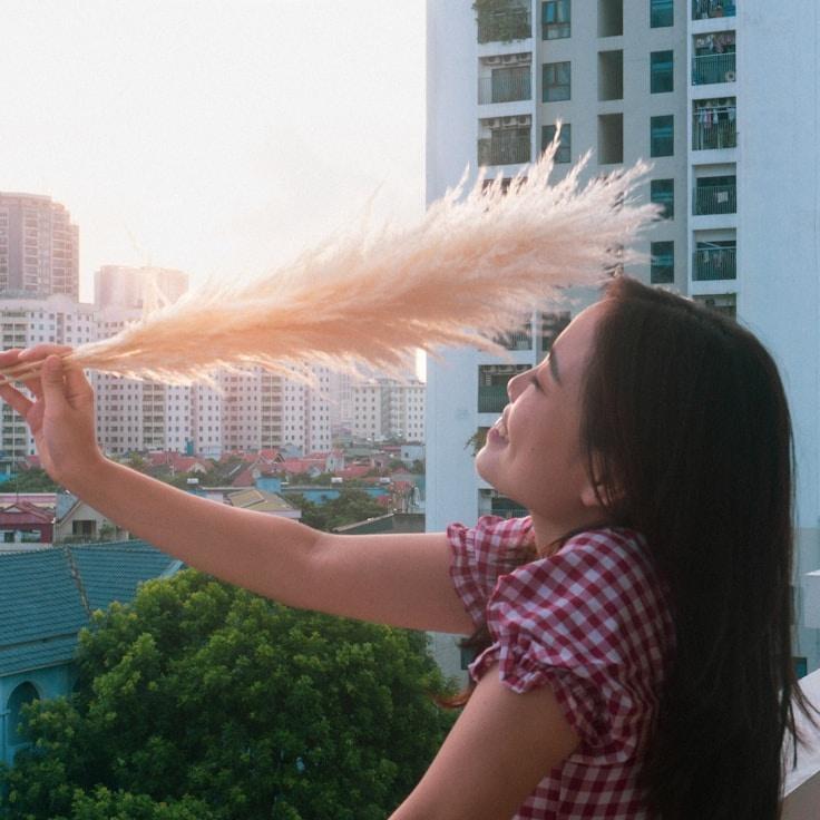 Alex Jordan, Lead Design Curator at MossyTrailCabin, reviewing corporate floral arrangements